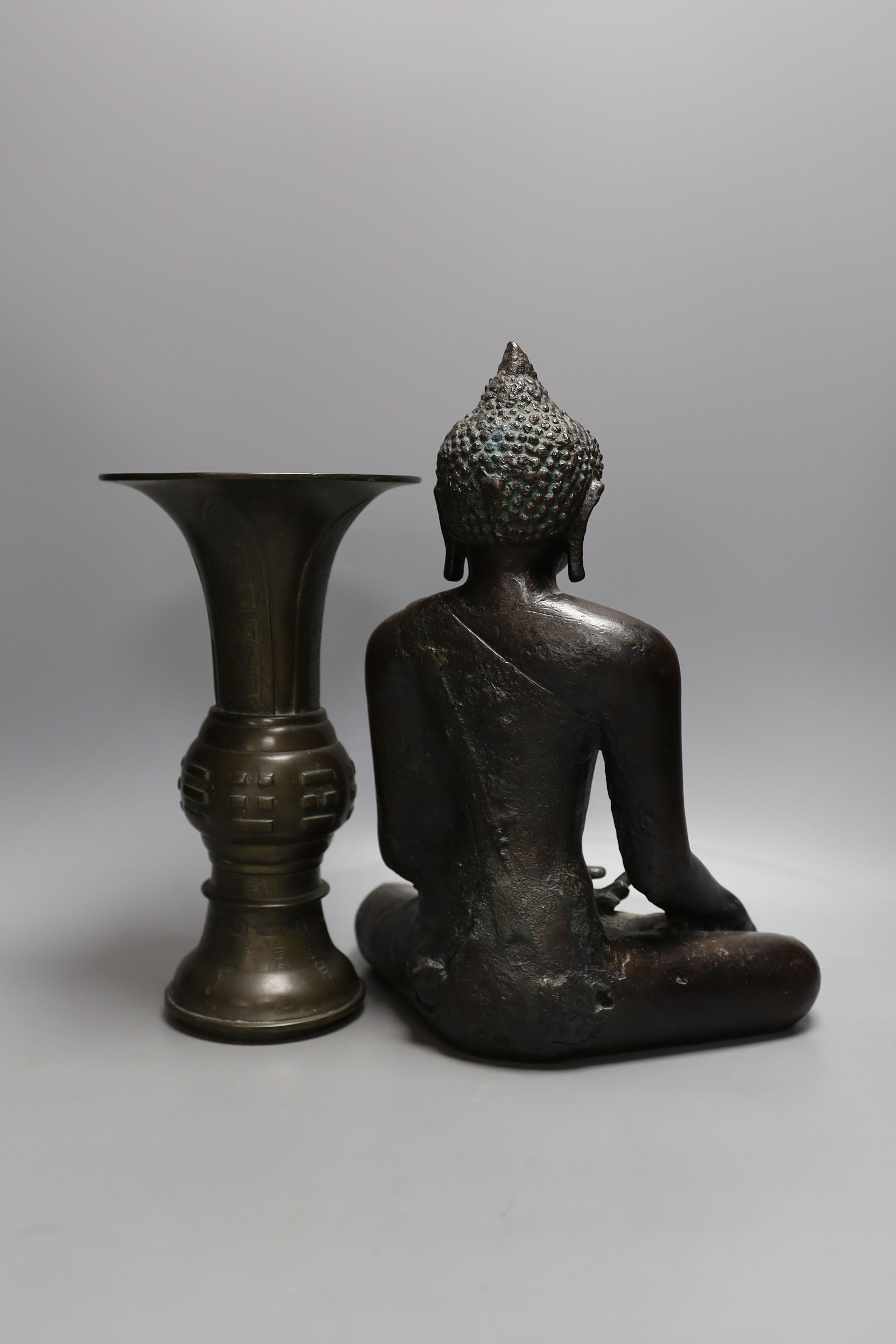 A Chinese bronze vase, 26cm high, inscription to base, together with a bronzed composition seated buddha figure